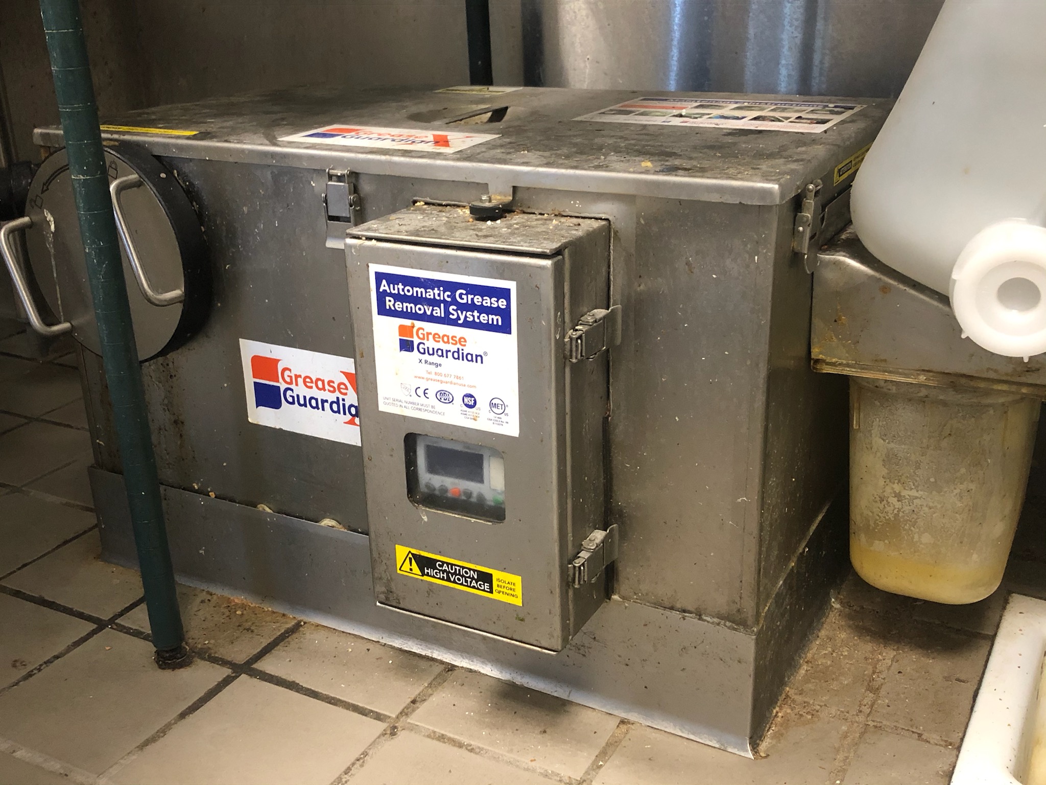Technician performing grease trap cleaning in Lynwood
