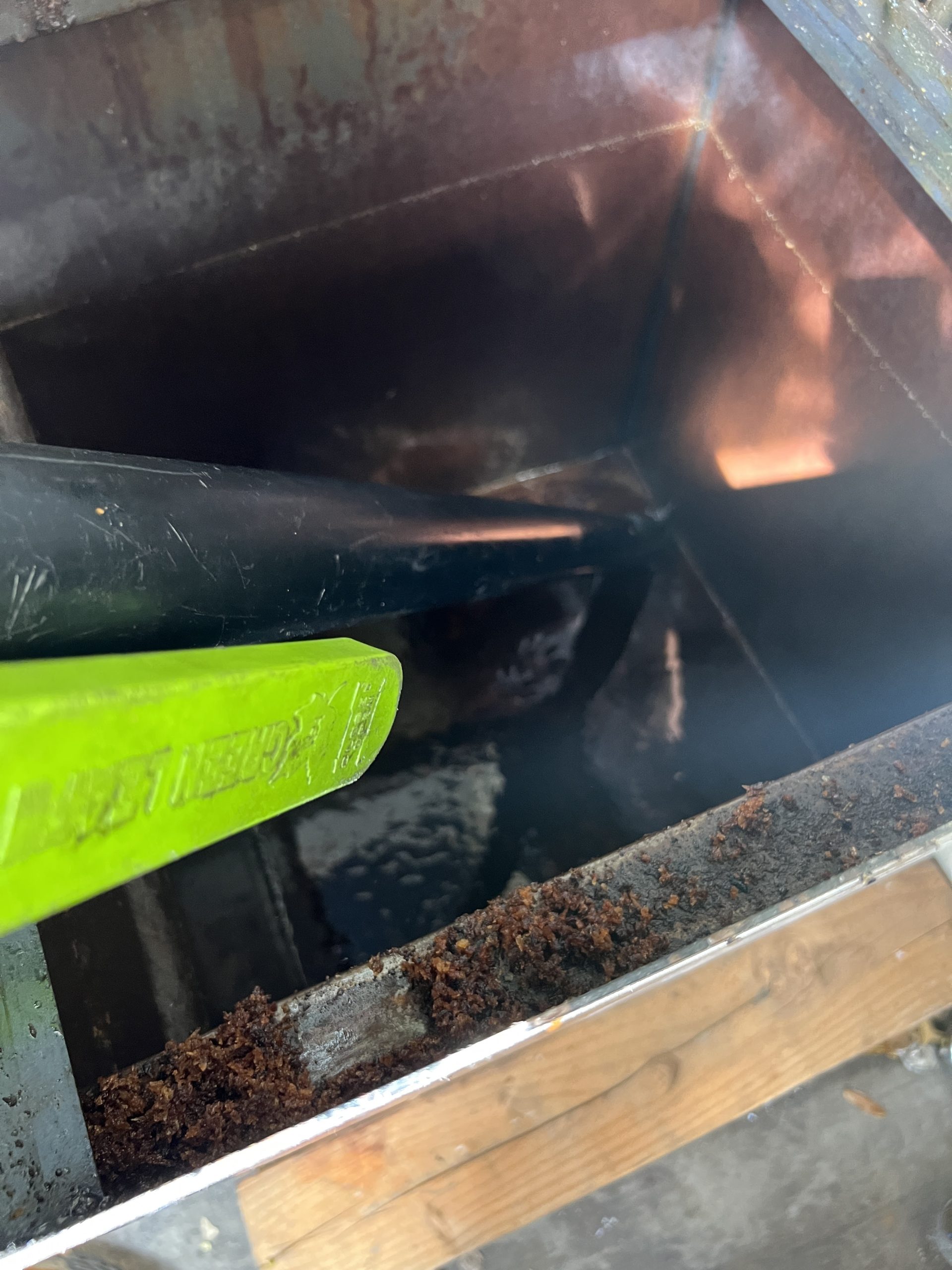 Technician performing grease trap cleaning in a La Verne